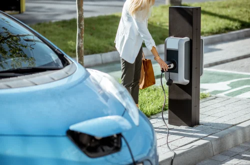 woman-charging-electric-car-2023-11-27-05-03-00-utc